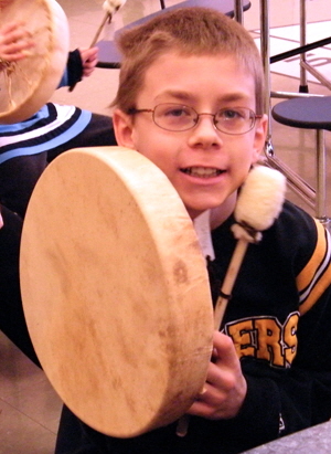 4th grader shows off his finished drum.