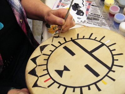 Kate Silberberg painting Hopi Sunface drum.